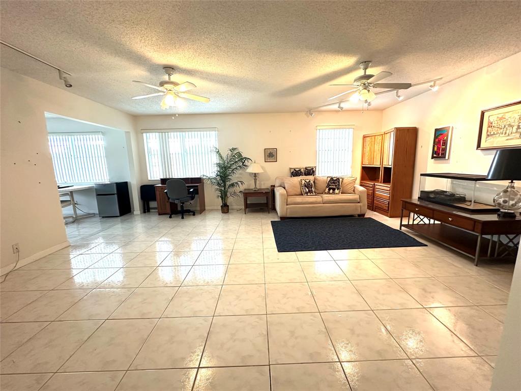 57 Markham C, Unit 57 Deerfield Beach, FL 33442 - Photo 20 of 76 a living room with furniture and a chandelier