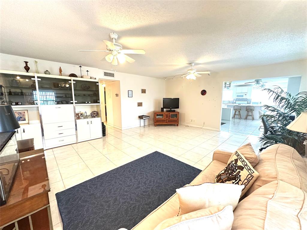 57 Markham C, Unit 57 Deerfield Beach, FL 33442 - Photo 22 of 76 a living room with furniture and a flat screen tv
