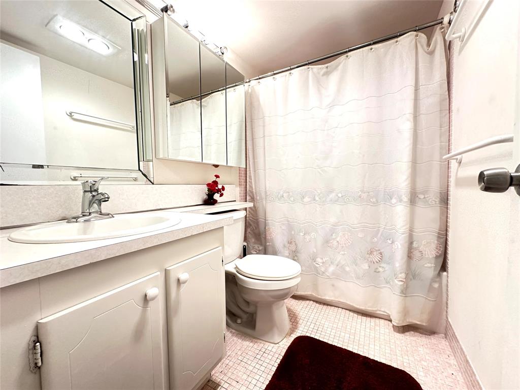 57 Markham C, Unit 57 Deerfield Beach, FL 33442 - Photo 23 of 76 a bathroom with a sink a toilet and a mirror