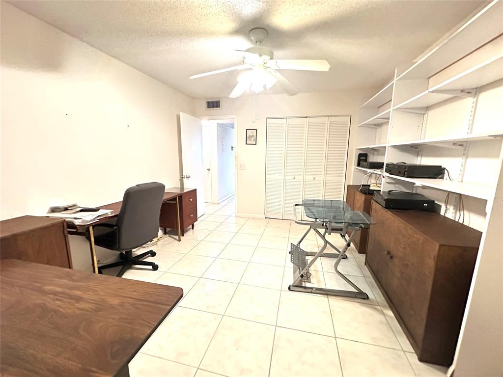 57 Markham C, Unit 57 Deerfield Beach, FL 33442 - Photo 28 of 76 a living room with furniture and a chandelier