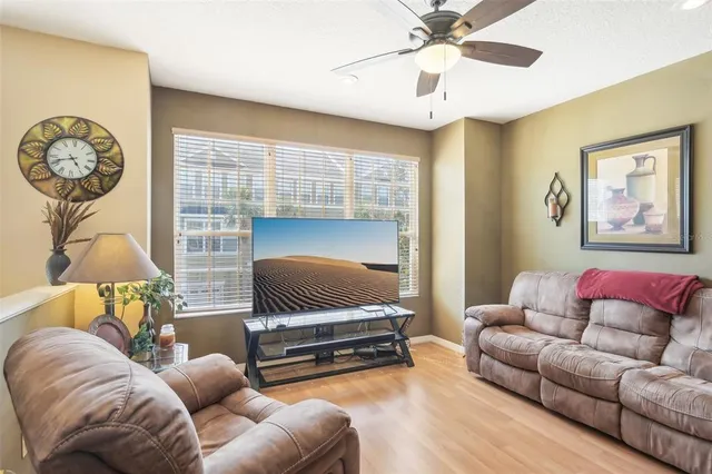 a living room with furniture and a chandelier
