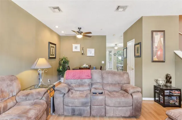 a living room with furniture gym equipment and a flat screen tv