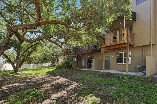 an aerial view of residential houses with outdoor space and trees all around