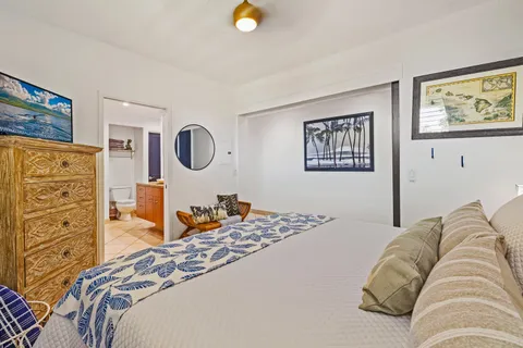 a bedroom with a bed and dresser