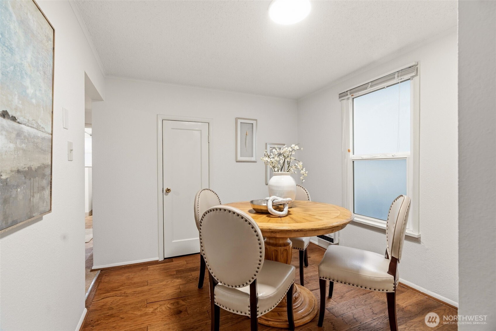 921 North 50th Street Seattle, WA 98103 - Photo 13 of 32 a view of a dining room with furniture and wooden floor