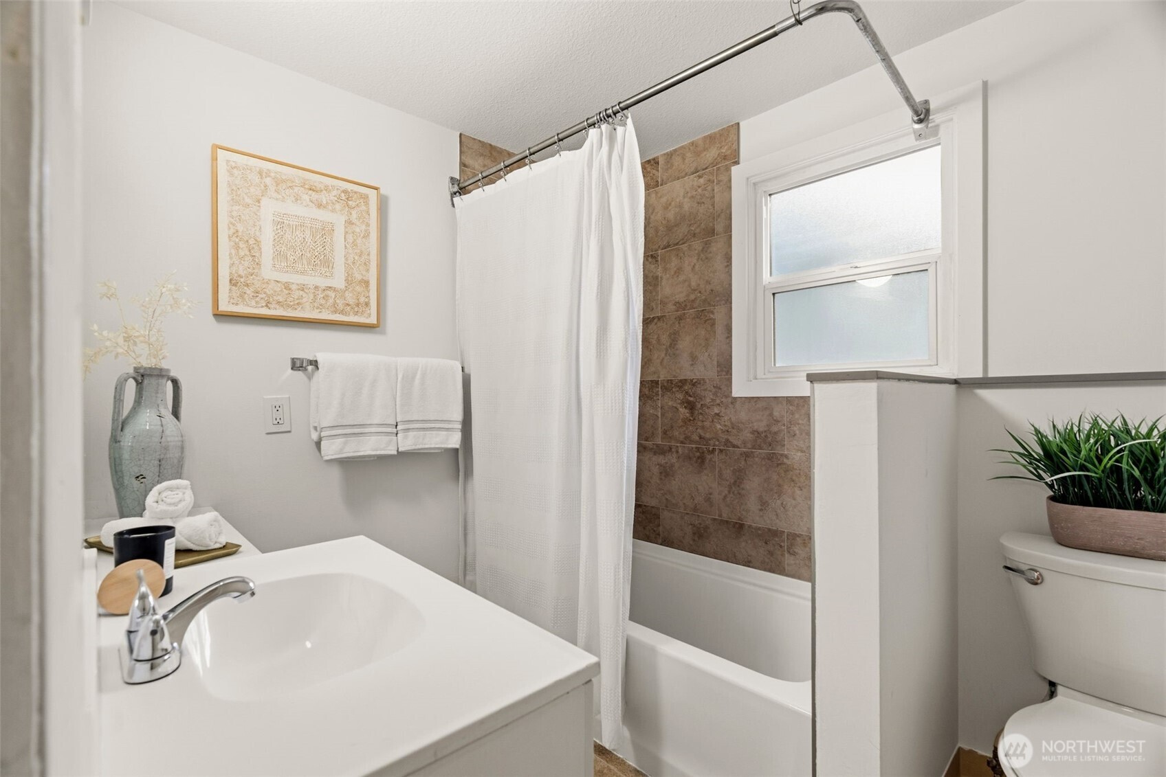 921 North 50th Street Seattle, WA 98103 - Photo 19 of 32 a bathroom with a sink toilet and shower