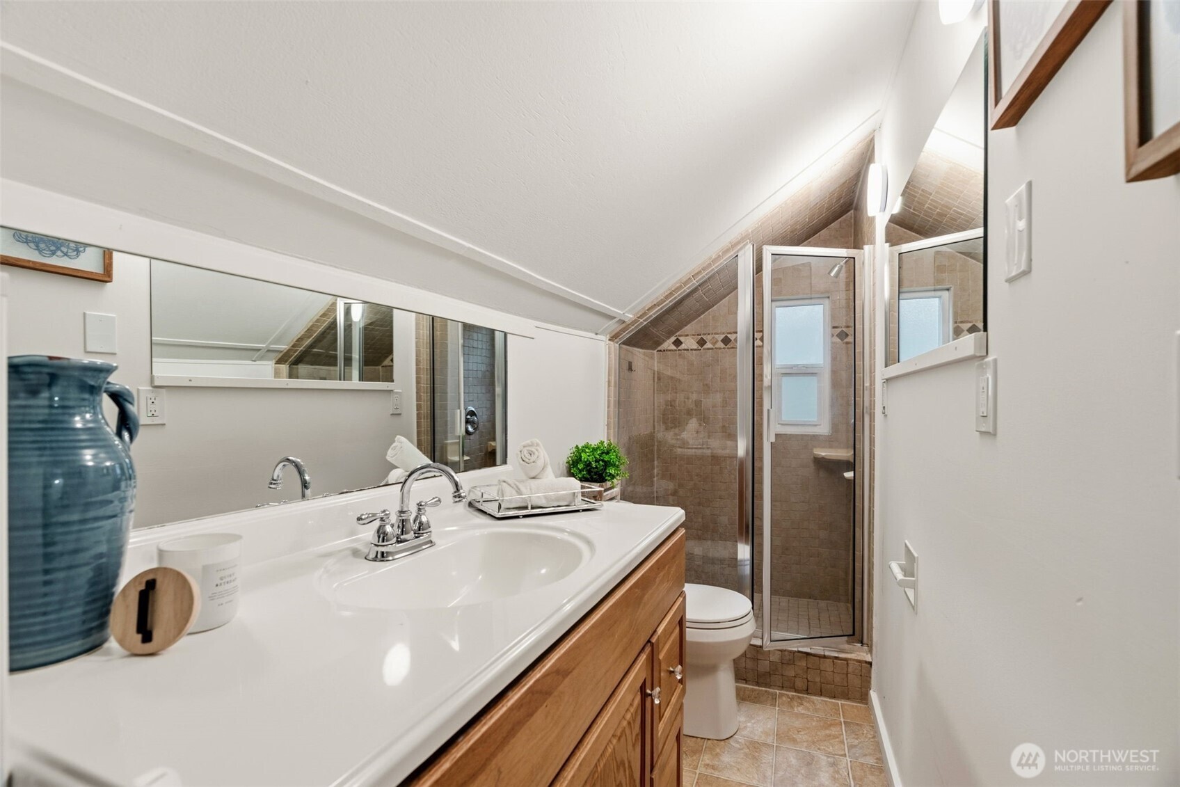 921 North 50th Street Seattle, WA 98103 - Photo 20 of 32 a bathroom with a sink and a mirror