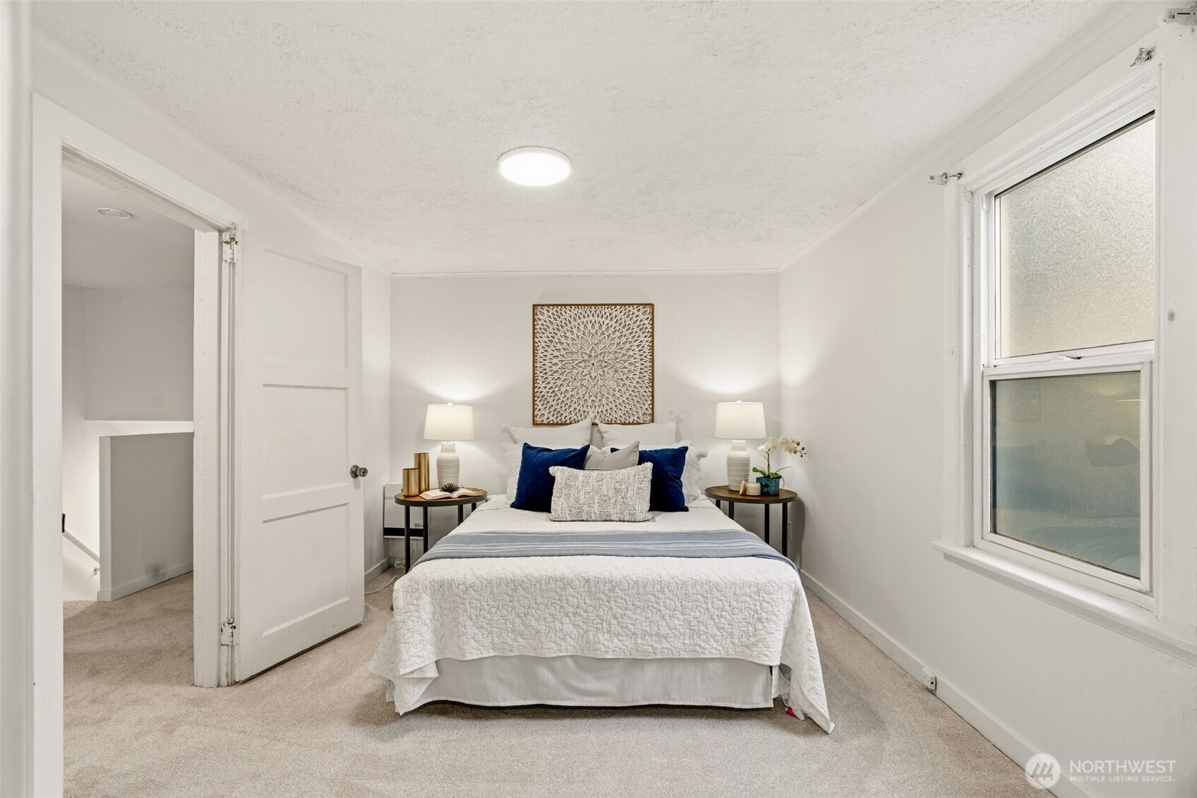 921 North 50th Street Seattle, WA 98103 - Photo 22 of 32 a bedroom with a bed and a window
