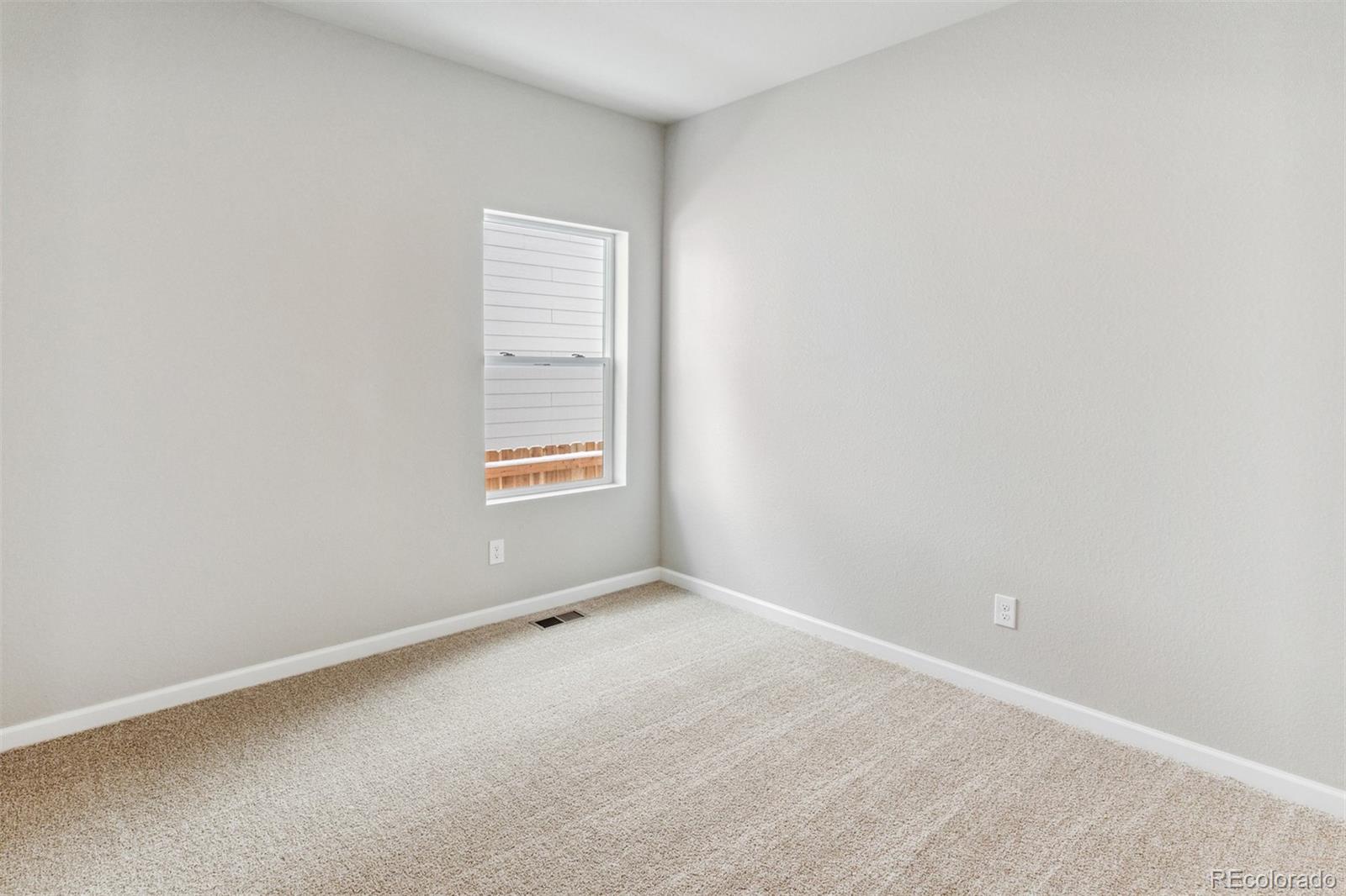 2144 Alyssa Street Fort Lupton, CO 80621 - Photo 14 of 38 a view of an empty room with a window