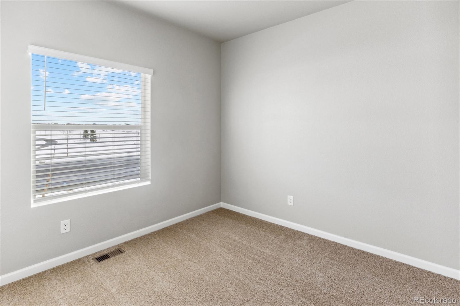 2144 Alyssa Street Fort Lupton, CO 80621 - Photo 15 of 38 a view of an empty room with a window