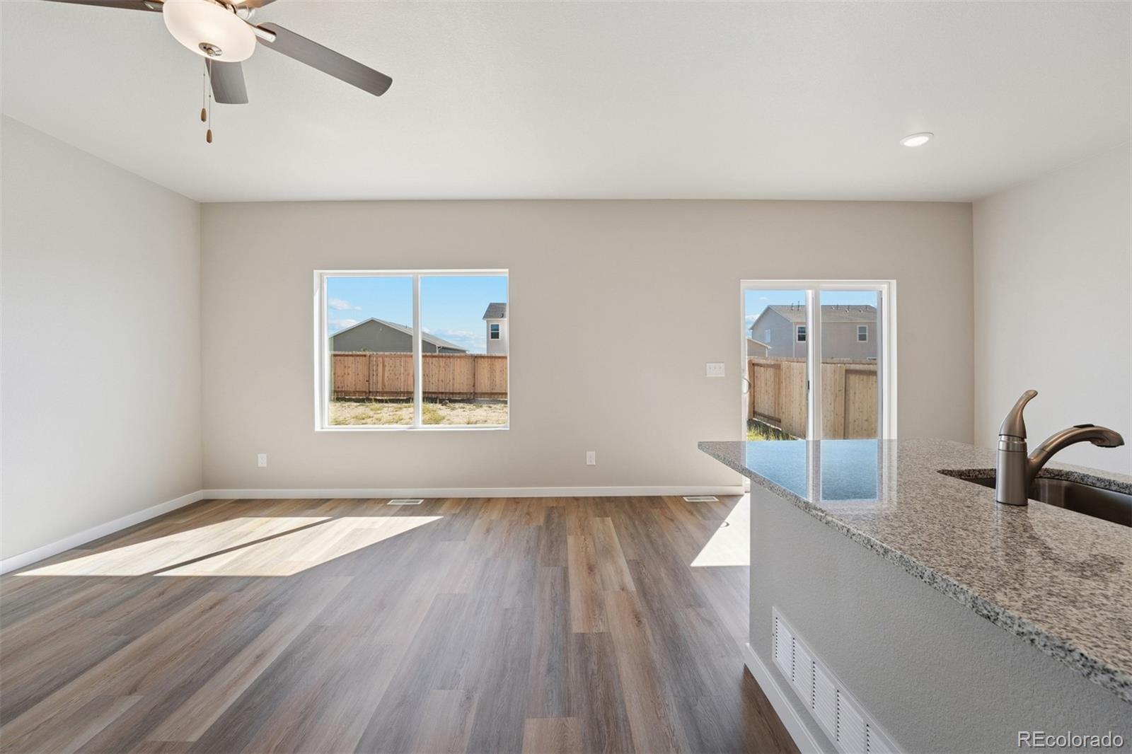 2144 Alyssa Street Fort Lupton, CO 80621 - Photo 4 of 38 a view of an empty room with window and wooden floor
