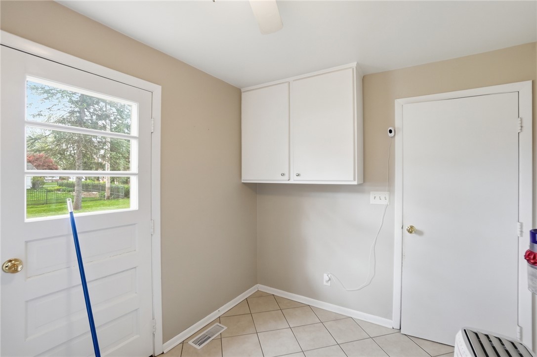150 Littlejohn Road Troy, OH 45373 - Photo 19 of 40 Bright utility room with natural light and functional storage cabinets.