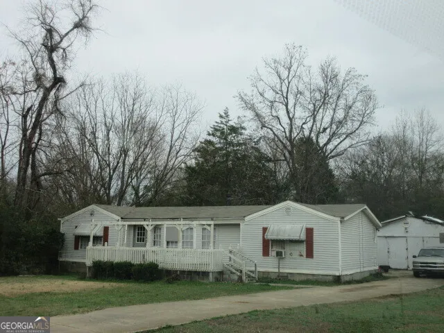 a view of house with yard and green space