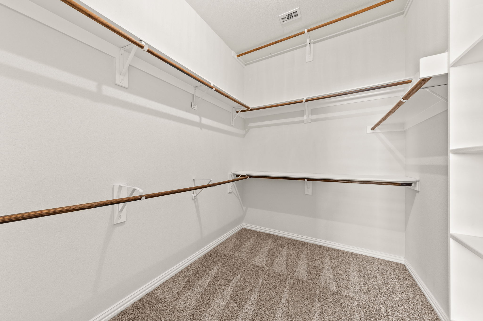 411 Tascate Street Georgetown, TX 78628 - Photo 26 of 41 Ample hanging space and shelving create an organized wardrobe solution for any collection.