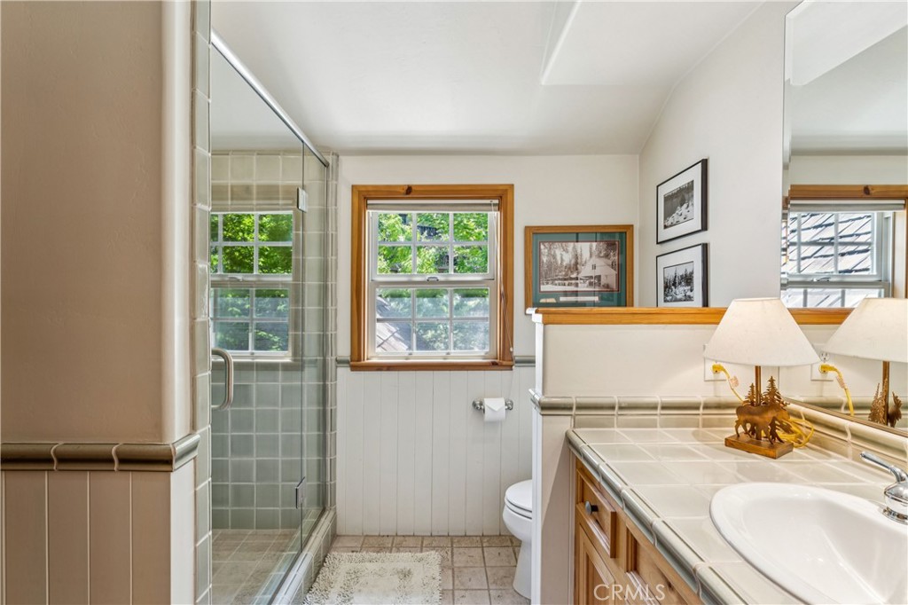 28971 North Shore Road Lake Arrowhead, CA 92352 - Photo 49 of 60 a bathroom with a sink toilet vanity and window