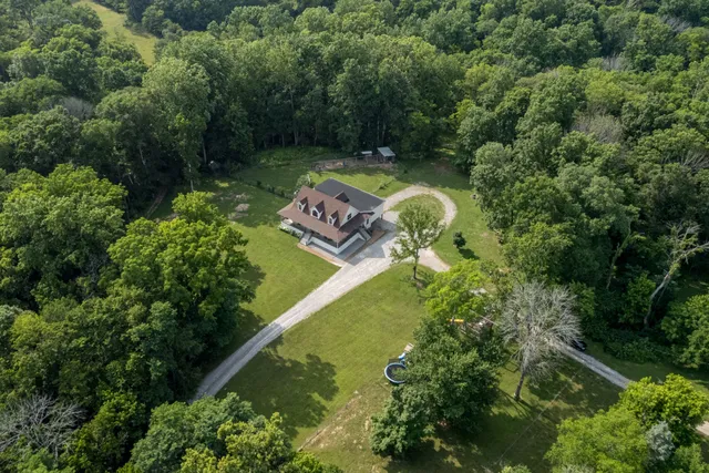 an aerial view of a house with a yard basket ball court and outdoor seating