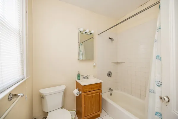 a white toilet sitting next to a bath tub