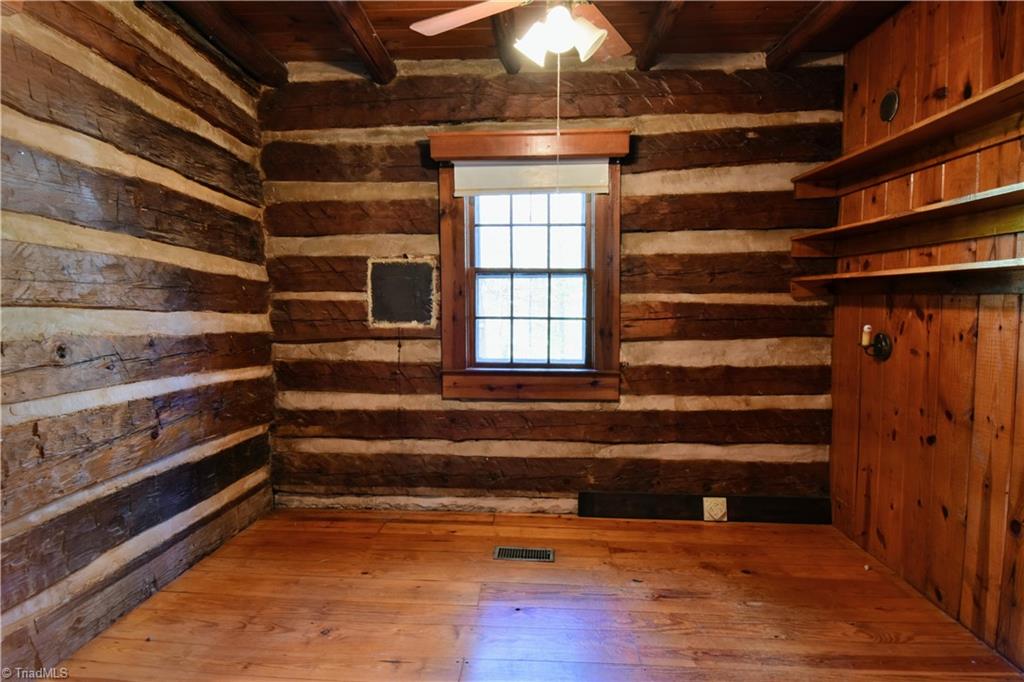 6068 Hedgerow Circle Clemmons, NC 27012 - Photo 18 of 35 Charming wall sconce light & shelves ideal for bedside or office area.