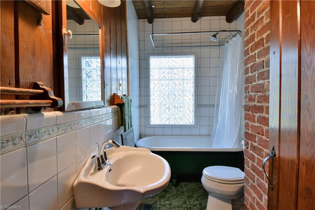 6068 Hedgerow Circle Clemmons, NC 27012 - Photo 20 of 35 Second bath features clawfoot tub, exposed brick, tile and warm wood accents.