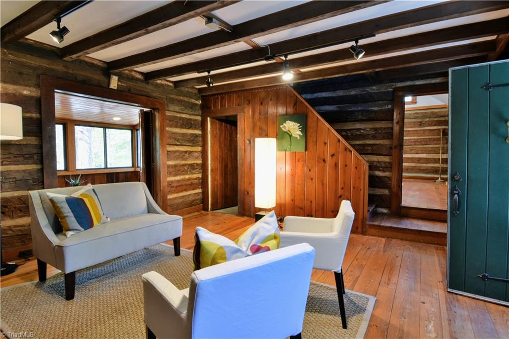 6068 Hedgerow Circle Clemmons, NC 27012 - Photo 3 of 35 Front living room accessed by charming entry door. Amazing hewn timber details!
