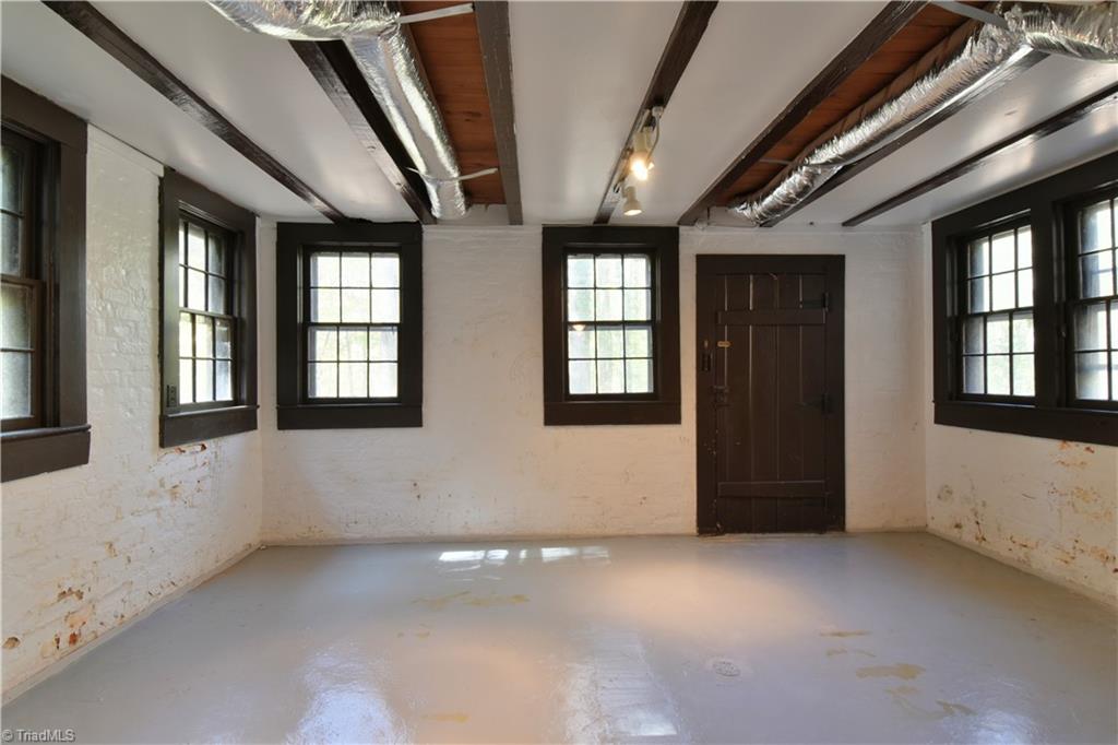 6068 Hedgerow Circle Clemmons, NC 27012 - Photo 23 of 35 Unfinished basement room with amazing natural light has been waterproofed with a warranteed system. Amazing custom door to the back yard.