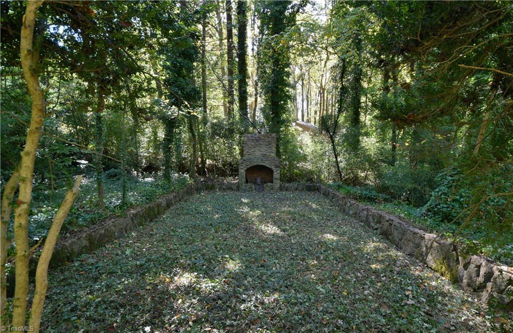 6068 Hedgerow Circle Clemmons, NC 27012 - Photo 34 of 35 This outdoor space with fireplace #7 begs for a natural stone base and fairy lights twinkling overhead through the trees. Nestled in a hammock, can you feel it? Happiness