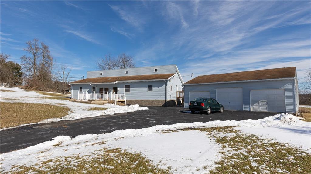a view of a house with snow on the road