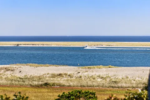 a bathroom with a granite countertop sink toilet and a mirror
