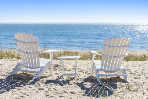 a bedroom with furniture and a large window