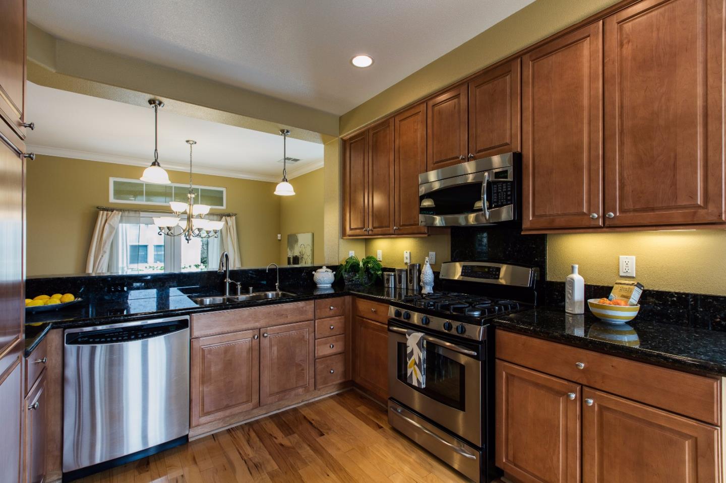 335 Ascente Commons San Jose, CA 95125 - Photo 6 of 38 a kitchen with granite countertop a sink cabinets and stainless steel appliances