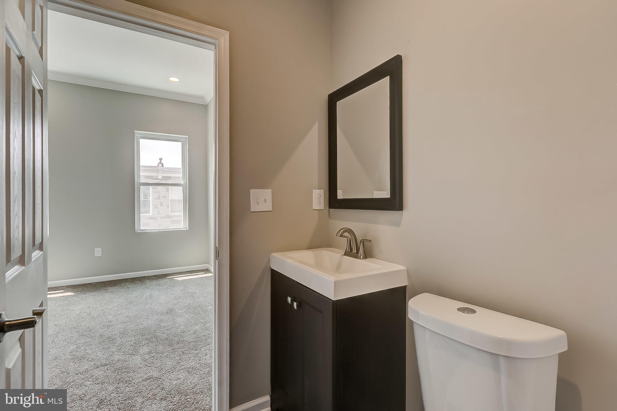 157 North Curley Street Baltimore, MD 21224 - Photo 15 of 30 Front Bedroom - Attached Full Bath