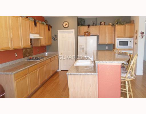 849 Wintersweet Road Henderson, NV 89015 - Photo 10 of 18 Kitchen. Granite Counters, Large Breakfast Bar, Walk In Pantry