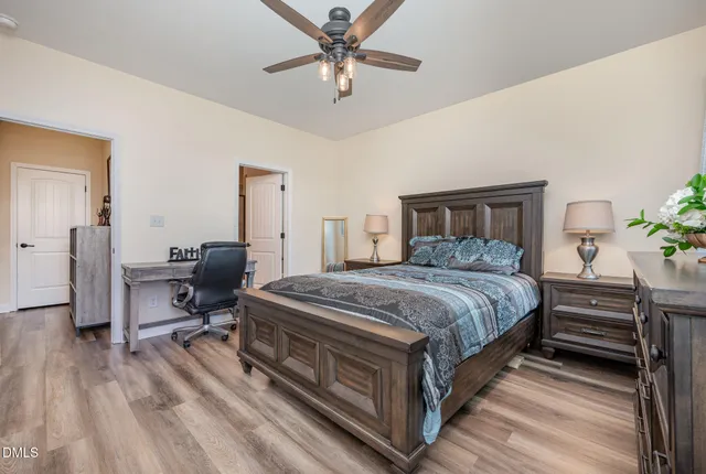 a kitchen with stainless steel appliances granite countertop a sink dishwasher a stove a refrigerator and cabinets with wooden floor