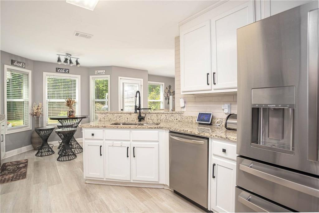236 Camp Court Bethlehem, GA 30620 - Photo 25 of 51 a kitchen with stainless steel appliances granite countertop a sink stove and refrigerator