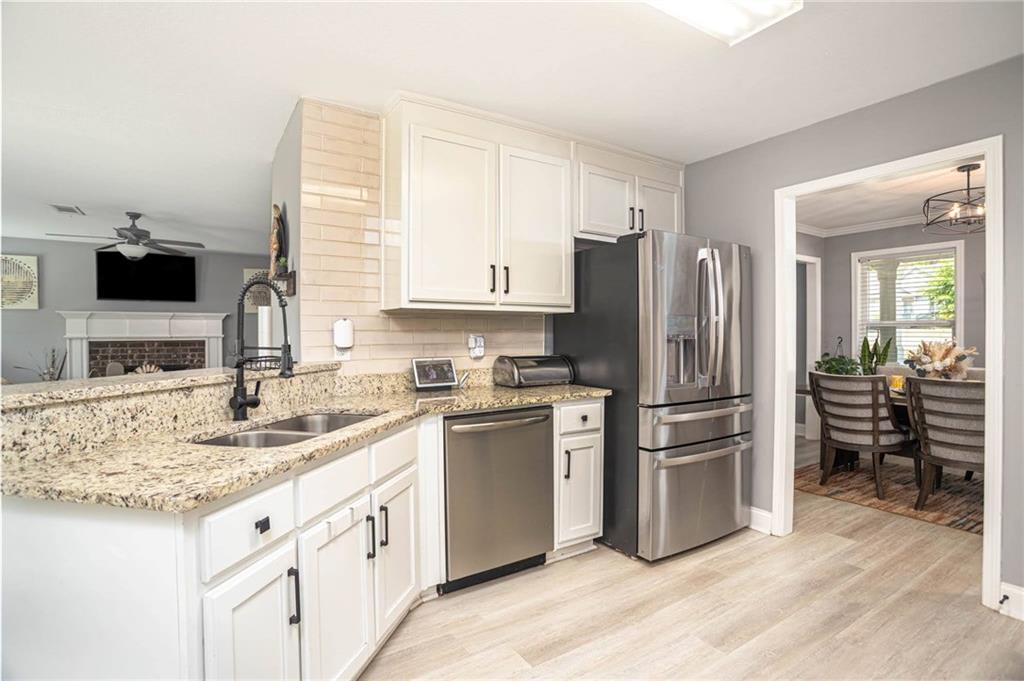 236 Camp Court Bethlehem, GA 30620 - Photo 27 of 51 a kitchen with granite countertop a refrigerator stove and sink