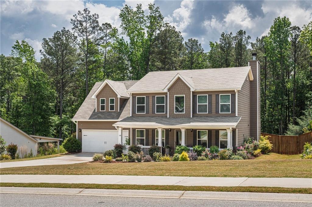 236 Camp Court Bethlehem, GA 30620 - Photo 3 of 51 a front view of a house with a garden