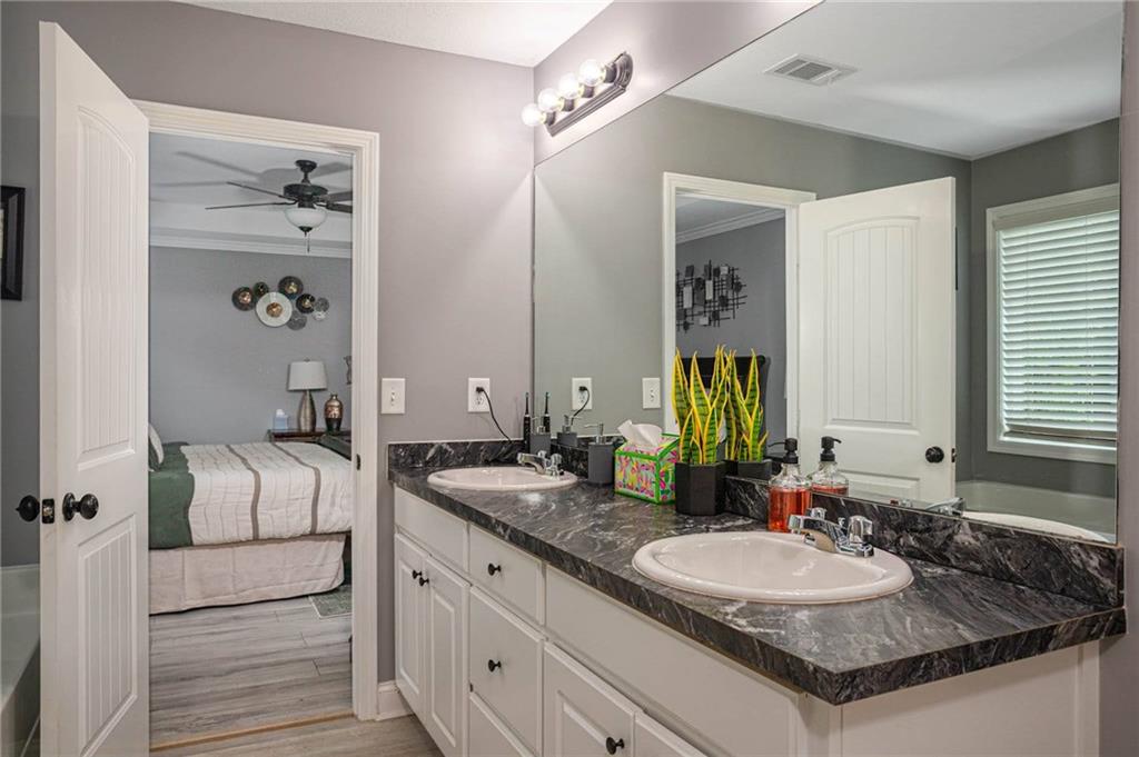 236 Camp Court Bethlehem, GA 30620 - Photo 35 of 51 a en suite bathroom with a granite countertop sink and a mirror