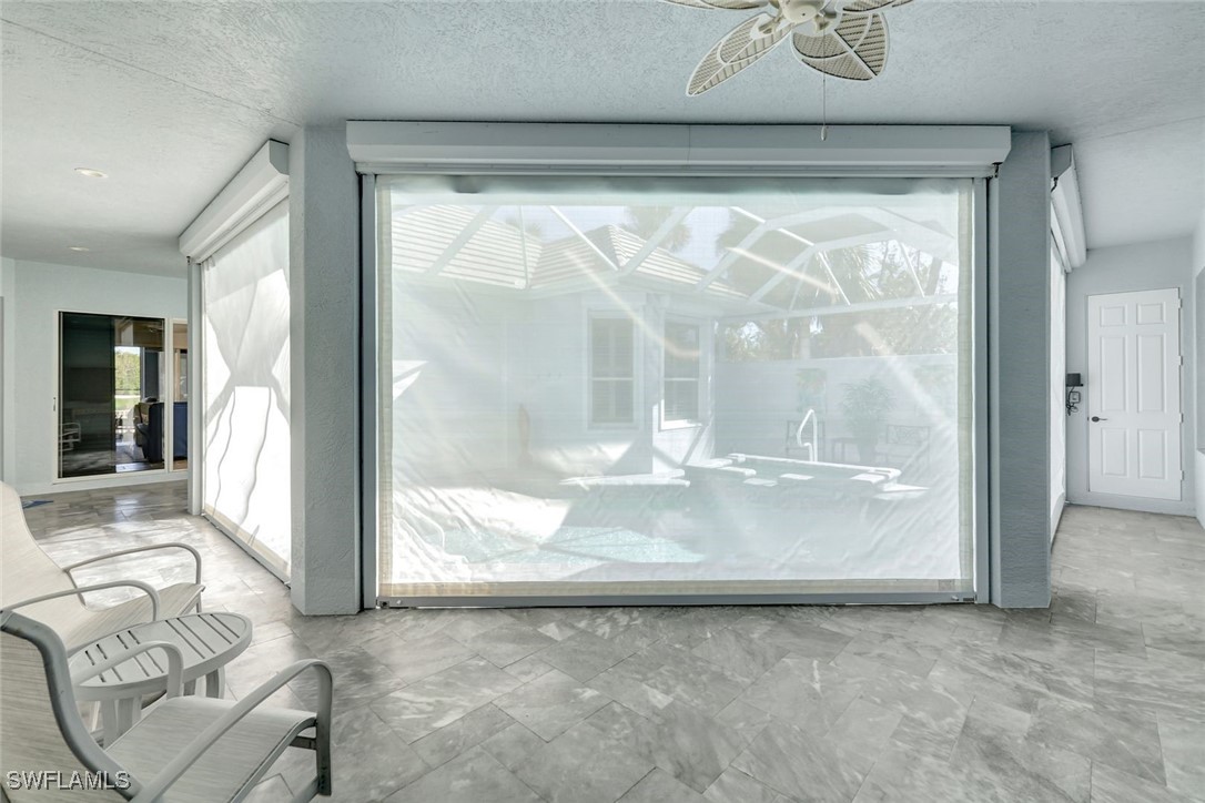 2450 Wulfert Road Sanibel, FL 33957 - Photo 38 of 44 a view of a livingroom with wooden floor and a large window