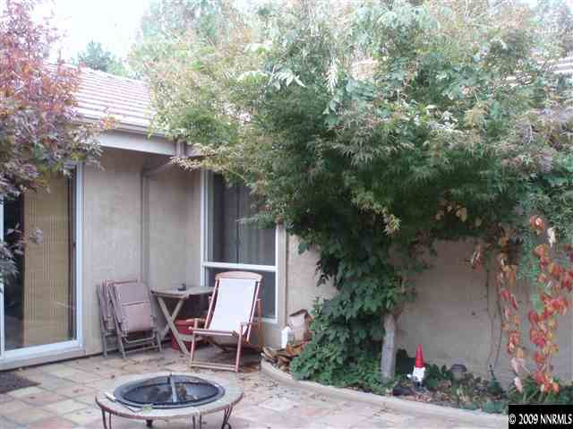 4145 Longknife Road Reno, NV 89519 - Photo 8 of 9 a couple of chairs sitting in front of a house