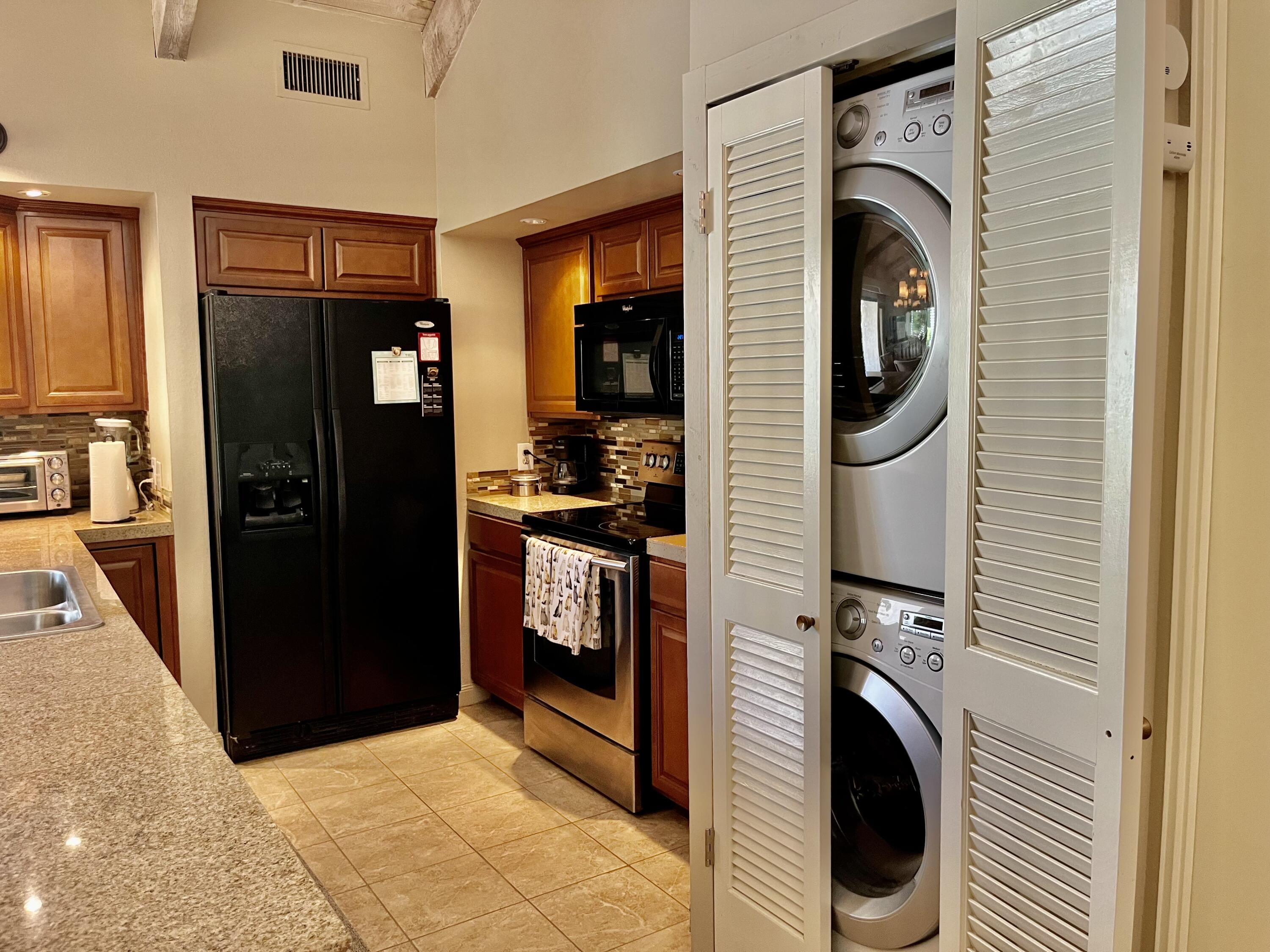 127 South Racquet Club Drive Rancho Mirage, CA 92270 - Photo 12 of 25 a view of a kitchen with washer and dryer