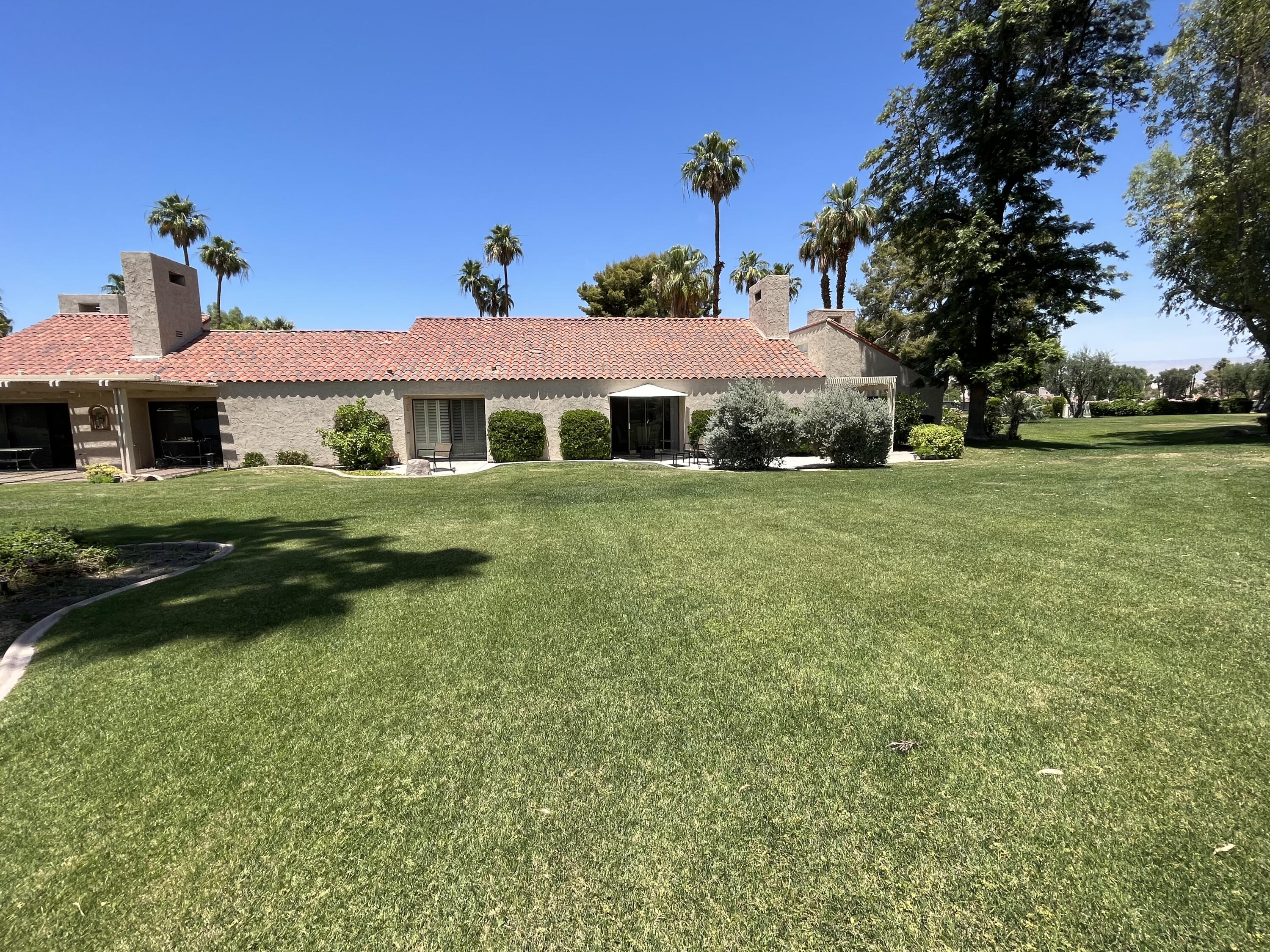 127 South Racquet Club Drive Rancho Mirage, CA 92270 - Photo 13 of 25 a front view of a house with a garden