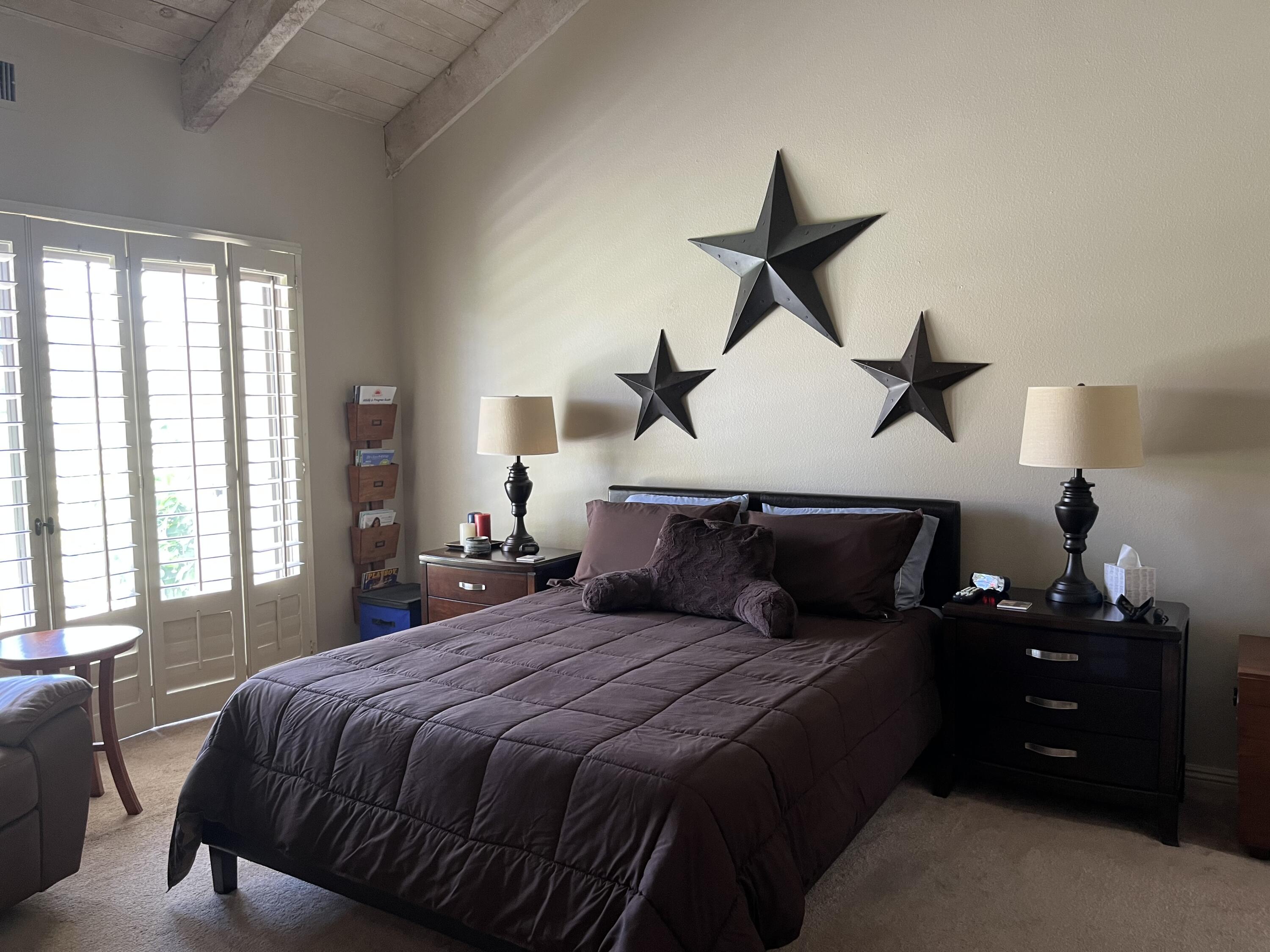 127 South Racquet Club Drive Rancho Mirage, CA 92270 - Photo 14 of 25 a bedroom with a bed and window