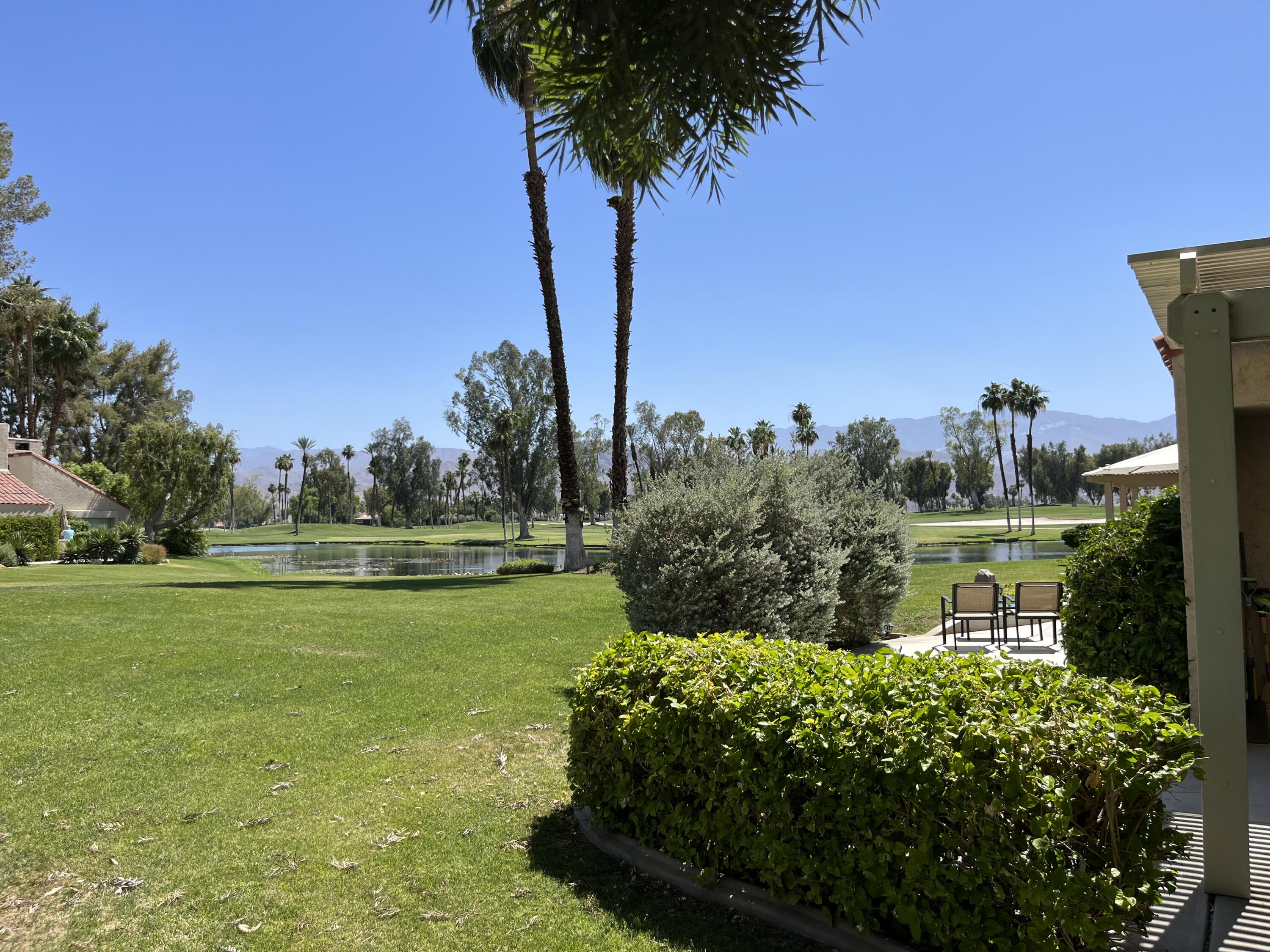 127 South Racquet Club Drive Rancho Mirage, CA 92270 - Photo 21 of 25 a view of a golf course with a lake
