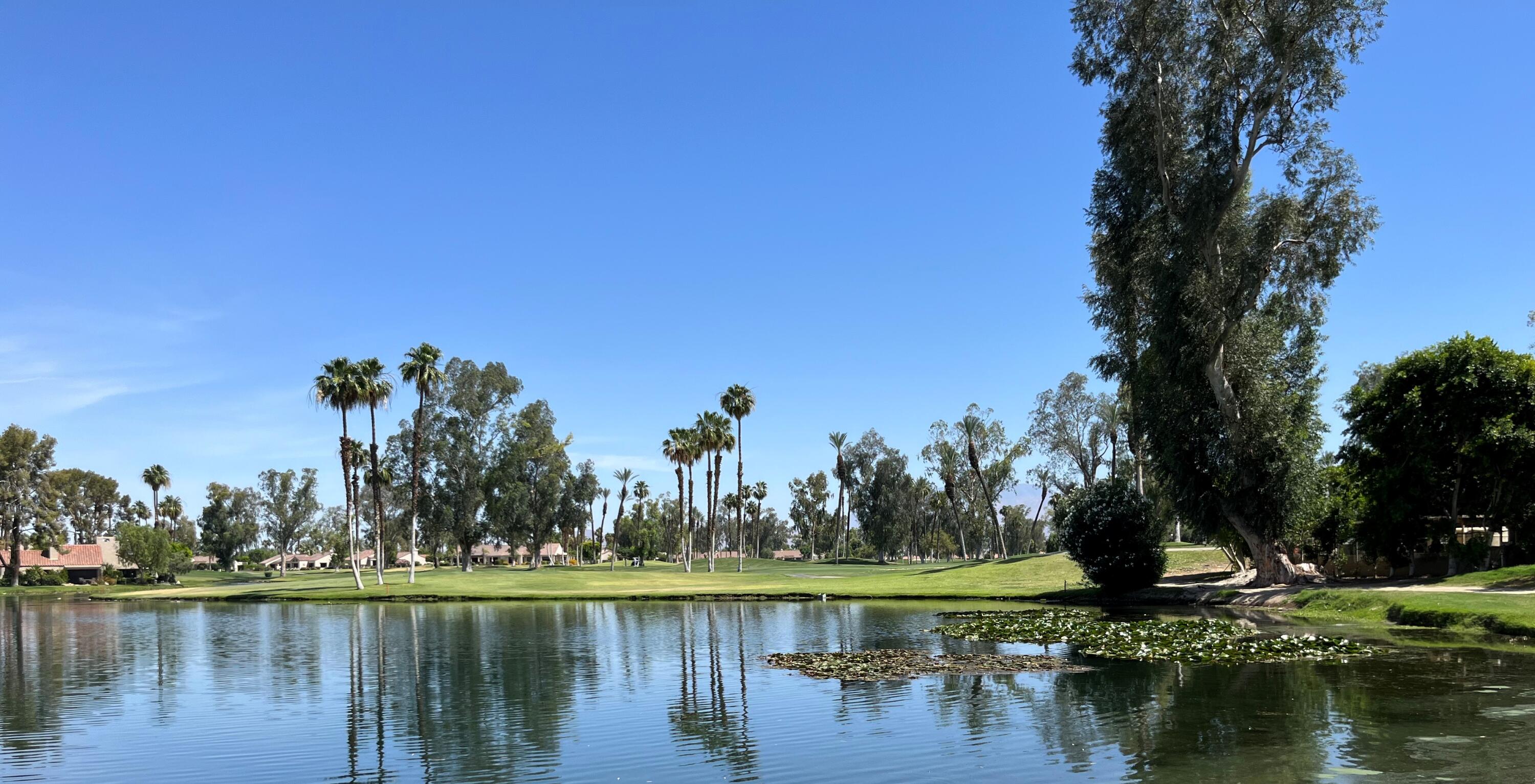 127 South Racquet Club Drive Rancho Mirage, CA 92270 - Photo 22 of 25 a view of a lake with houses in the back