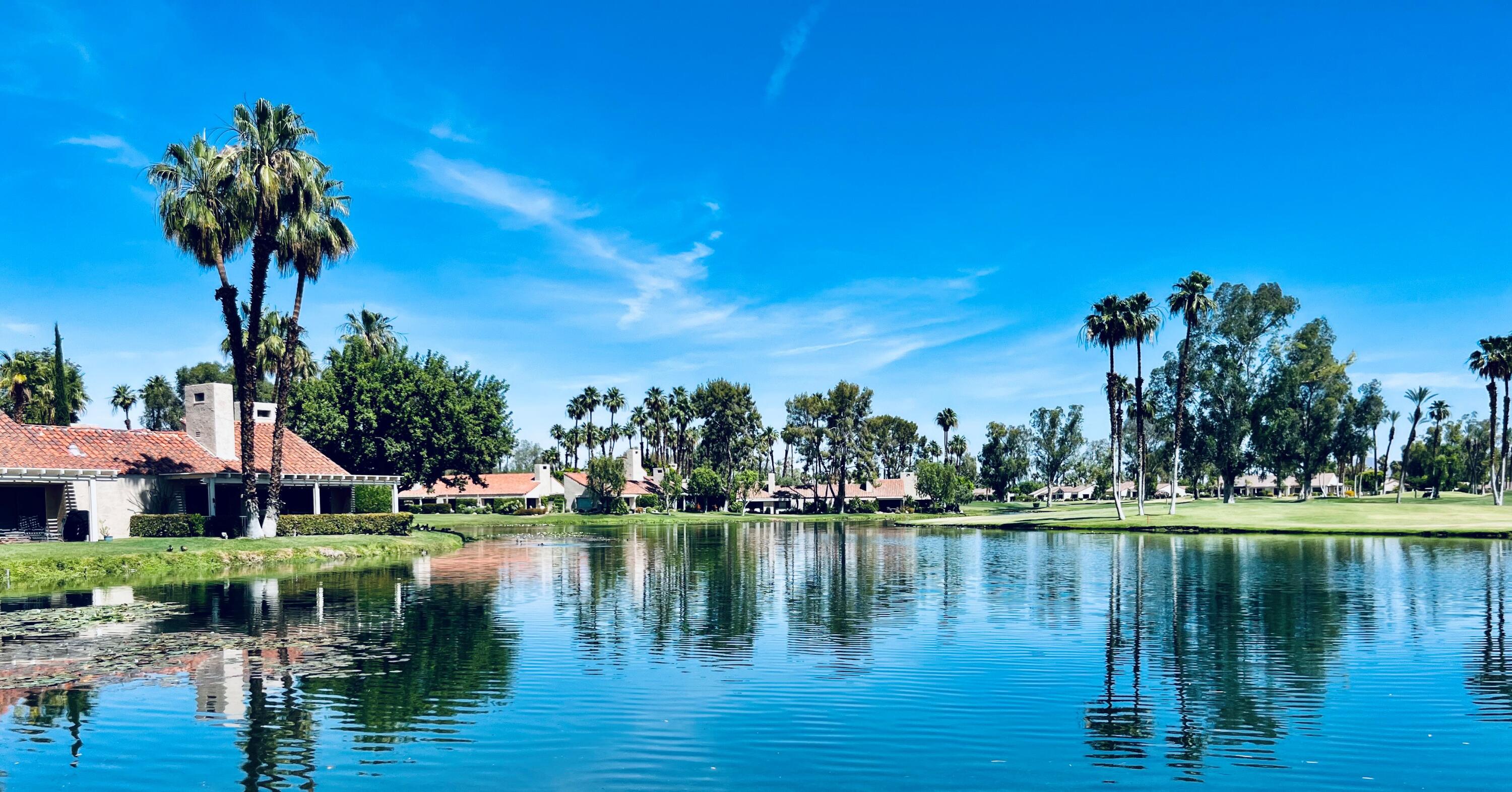 127 South Racquet Club Drive Rancho Mirage, CA 92270 - Photo 3 of 25 a view of a lake with houses