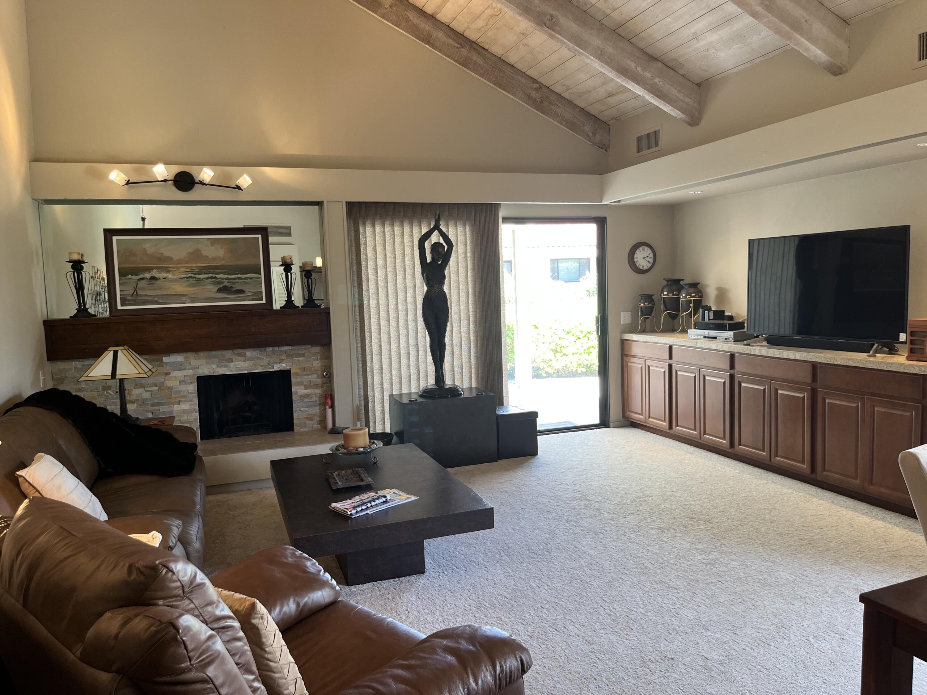 127 South Racquet Club Drive Rancho Mirage, CA 92270 - Photo 5 of 25 a living room with furniture and a fireplace