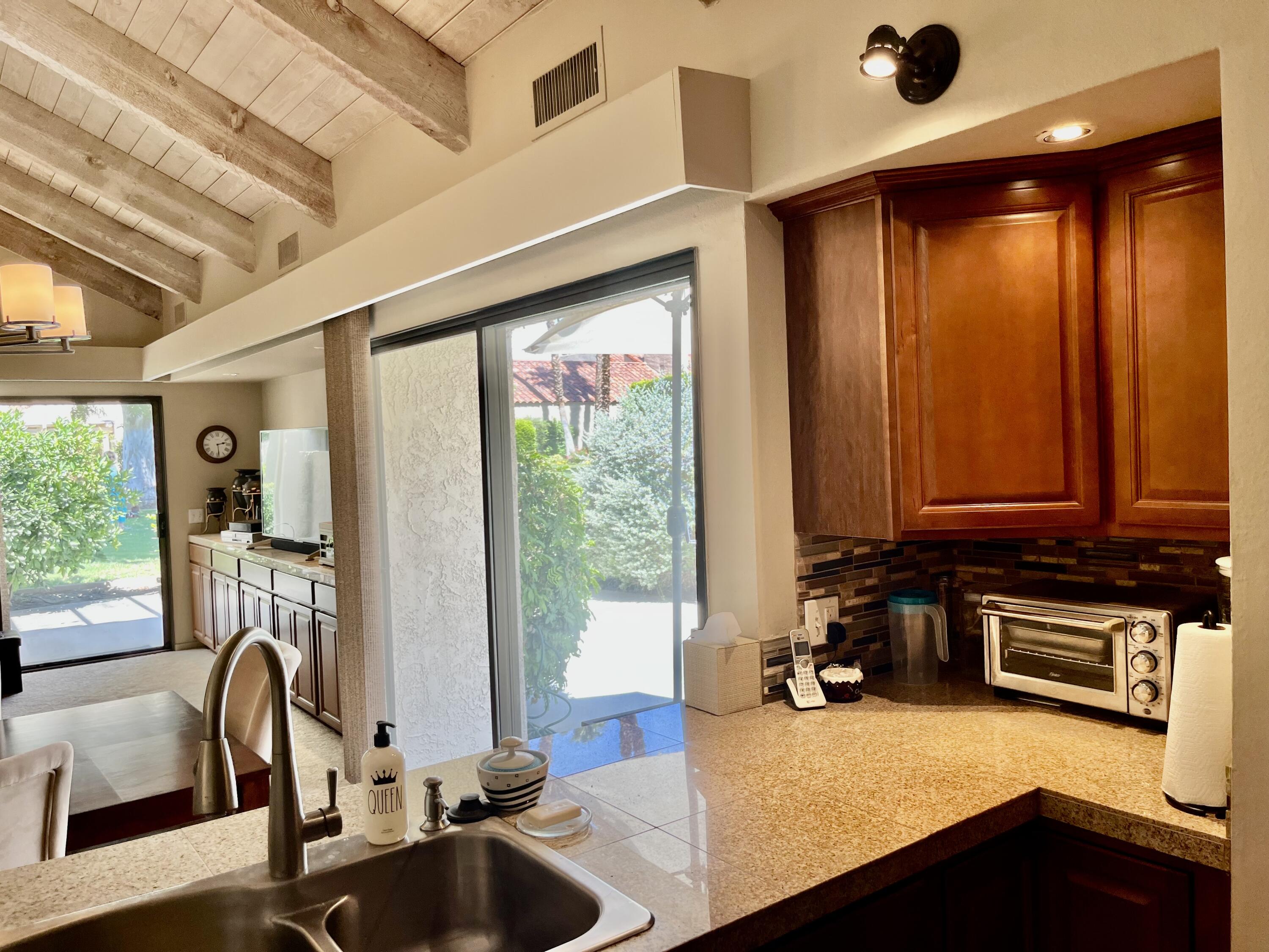 127 South Racquet Club Drive Rancho Mirage, CA 92270 - Photo 10 of 25 a view of a kitchen with a sink and a large window