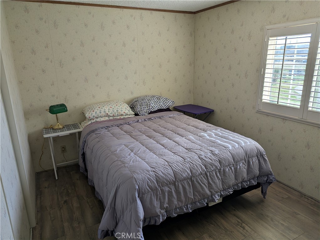 13182 Begonia Road Victorville, CA 92392 - Photo 11 of 17 a bed sitting in a bedroom next to a window