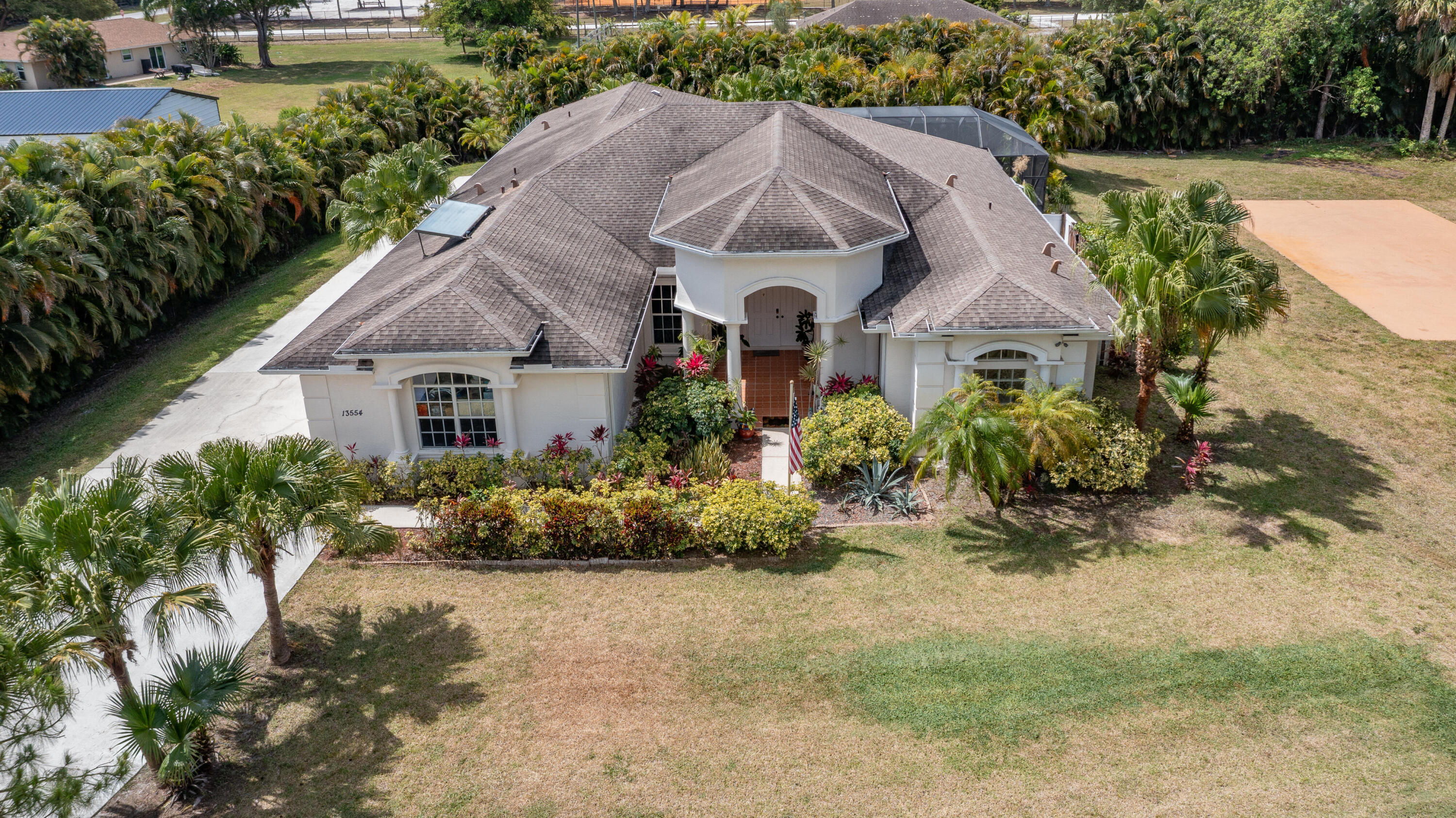 13554 86th Road North West Palm Beach, FL 33412 - Photo 2 of 58 a aerial view of a house with a yard and potted plants