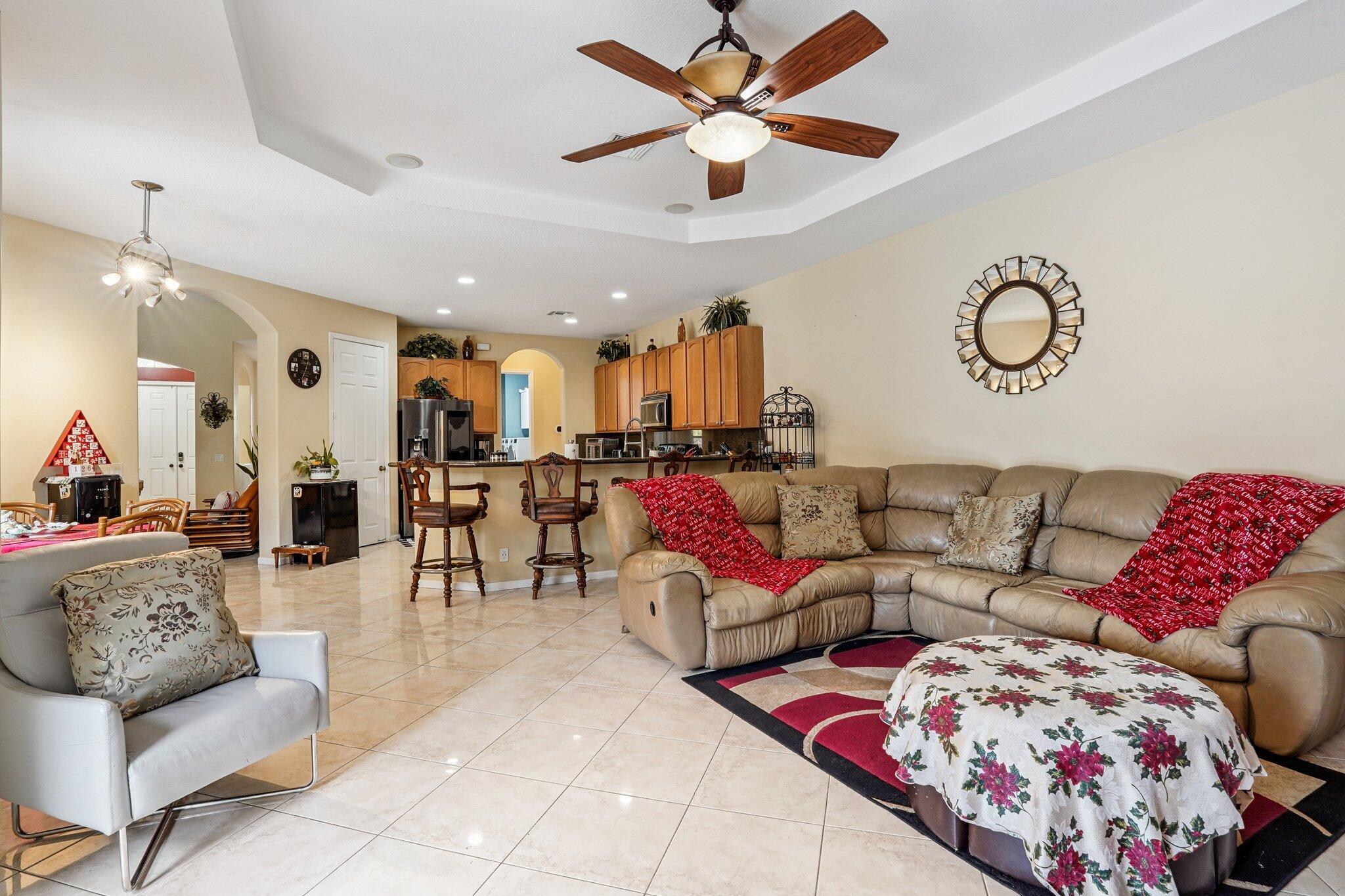 13554 86th Road North West Palm Beach, FL 33412 - Photo 29 of 58 a living room with furniture kitchen view and a chandelier